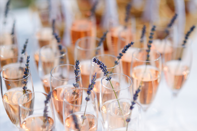 Image of glasses of with pink champagne decorated with lavender.