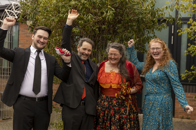 Image of the wedding party celebrating.