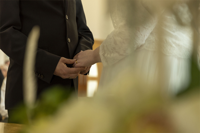 Image of the bride and groom holding hands.