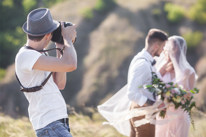 Image of a photographer taking pictures of the couple.