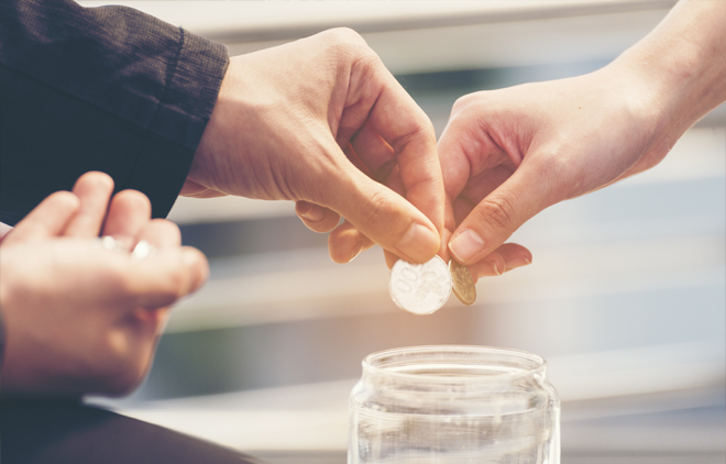 Image of couple putting money into a jar.