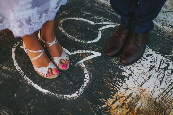 Image of a bride and grooms feet.