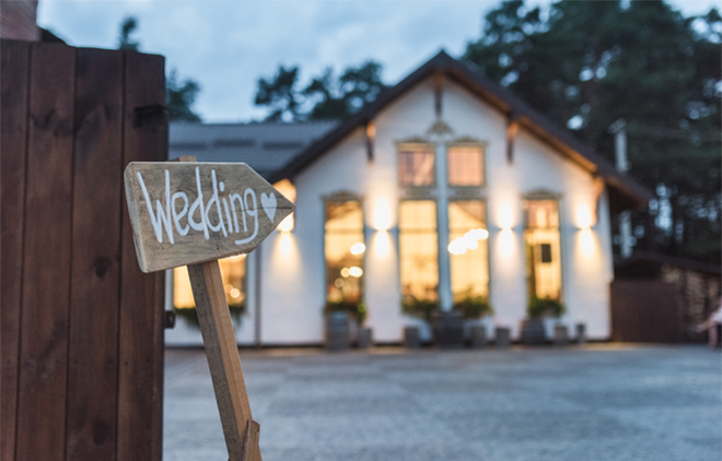 Image of a building and a wedding sign.