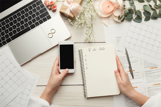 Image of a laptop, rings, phone and notepad. 